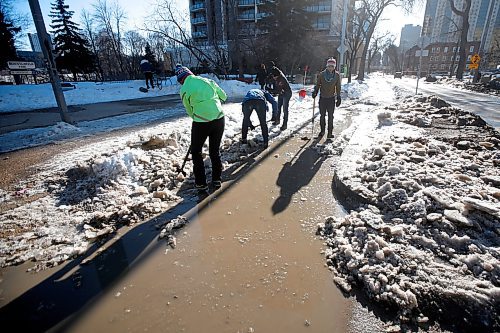 JOHN WOODS / WINNIPEG FREE PRESS
Cyclist Hillary Rosentreter, left, and other cyclists clear an Assiniboine Avenue bike path of ice  Sunday, March 26, 2023. 

Re: Malak