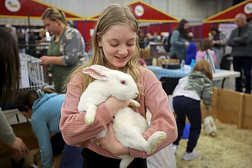 Emma Barkley holds a rabbit in the petting zoo during the opening day of the Royal Manitoba Winter Fair at the Keystone Centre on Monday. (Tim Smith/The Brandon Sun)
