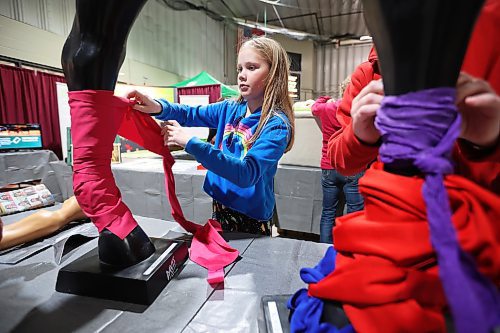 Brooke Robins practises tying leg wraps for horses during a visit to the Royal Manitoba Winter Fair at The Keystone Centre on the opening day, Monday. (Tim Smith/The Brandon Sun)
