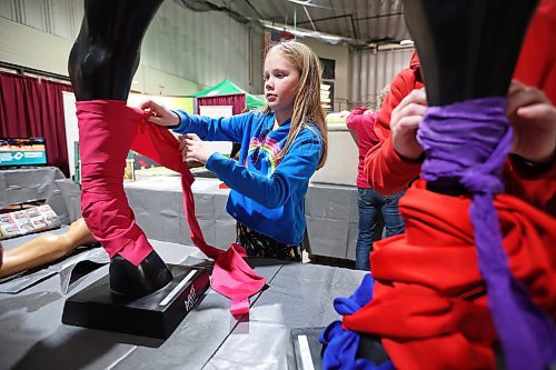 27032023
Brooke Robins practices tying leg wraps for horses during a visit to the Royal Manitoba Winter Fair at The Keystone Centre on the opening day, Monday.
(Tim Smith/The Brandon Sun)
