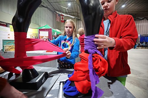 27032023
Siblings Brooke and Lucas Robins practice tying leg wraps for horses during a visit to the Royal Manitoba Winter Fair at The Keystone Centre on the opening day, Monday.
(Tim Smith/The Brandon Sun)
