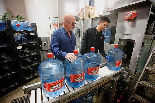 JOHN WOODS / WINNIPEG FREE PRESS
Chris Garrick, left, president of Jackson Springs Water Corporation, photographed with production staffer Mark in his water bottling facility in Winnipeg Monday, March 27, 2023. 

Re: pursaga