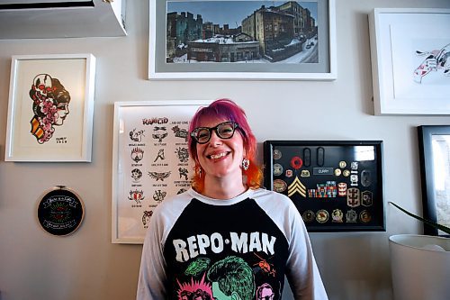 JOHN WOODS / WINNIPEG FREE PRESS
Em Curry, organizer of the Winnipeg Punk Rock Flea Market who has gathered together forty vendors to kick off the inaugural market, is photographed with some product in her home in Winnipeg Monday, March 27, 2023. Curry stands below a photo of The Albert, one of Winnipeg&#x2019;s punk hot spots.

Re: Sanderson