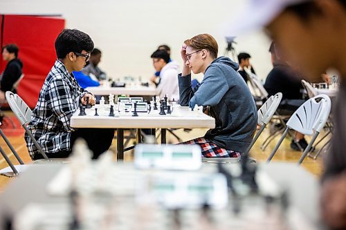 MIKAELA MACKENZIE / WINNIPEG FREE PRESS

Samuel Daya, gr. 11 student and leader of the Sisler chess club (left), and Yaroslav Kolesnykov, gr. 10 student from the Ukraine now attending Kelvin, play against each other in the Manitoba high school chess championship at Sisler High School in Winnipeg on Tuesday, March 28, 2023. Over 60 students participated in the event. For Tyler story.

Winnipeg Free Press 2023.