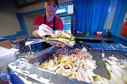 Katarina Kouroumali, co-owner of the Greek Food stands at the Royal Manitoba Winter Fair puts the finishing touches to a vegetarian falafal gyro on Wednesday afternoon. (Matt Goerzen/The Brandon Sun)