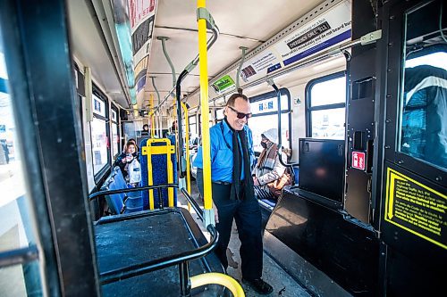 MIKAELA MACKENZIE / WINNIPEG FREE PRESS

Transit operator Joseph Fullmer checks his bus before taking off from the Garden City Shopping Centre bus loop in Winnipeg on Thursday, March 23, 2023. For Dave story.

Winnipeg Free Press 2023.