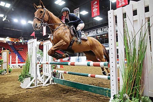 A horse and rider leap a fence during the Hunter Jumper show jumping at the Royal Manitoba Winter Fair on March 30. (Tim Smith/The Brandon Sun)
