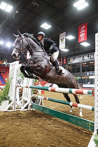 A horse and rider leap a fence during the Hunter Jumper show jumping at the Royal Manitoba Winter Fair on March 30. (Tim Smith/The Brandon Sun)