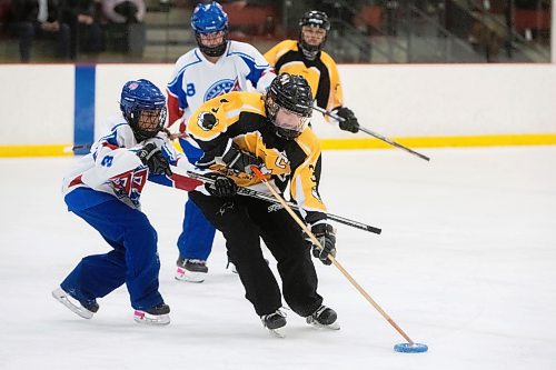 Mike Sudoma/Winnipeg Free Press
Ava Hepburn of U14AA Team Manitoba Ringette keeps the ring away from Team Alberta as the teams faces off at Seven Oaks Arena Thursday
March 30, 2023 