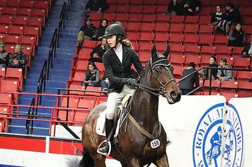 Tyne Alliban competes in Thursday's jumping competitions at Westoba Place alongside her thoroughbred Stormy Spirited. Alliban and her family travelled all the way from Carstairs, Alta. to take part in this year's Royal Manitoba Winter Fair Horse Show. (Kyle Darbyson/The Brandon Sun)