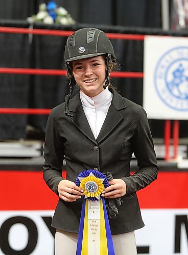 Tyne Alliban showcases the ribbon she won after placing second in Thursday's one-metre jumping competition at Westoba Place. (Kyle Darbyson/The Brandon Sun)