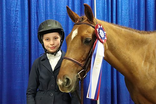 Aubree Swain poses for a photo next to her horse Partner in Crime at the Westoba Credit Union Agricultural Centre of Excellence on Thursday morning. This year's Royal Manitoba Winter Fair Horse show marks Swain's very first entry into official competition. (Kyle Darbyson/The Brandon Sun)