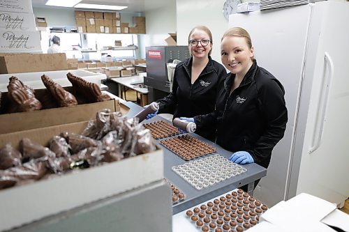RUTH BONNEVILLE / WINNIPEG FREE PRESS 

BIZ - Mordens&#x560;of Winnipeg

Photo of Blake Morden' granddaughters,  Mariel Morden-Miller (GM, right) and her sister Hilary Morden, who both work in the business. 


Story: Business Profile. Since 1959, Mordens&#x560;of Winnipeg has been creating award-winning chocolates and other products including nuts, peanut brittle and toasted marshmallows. After 64 years, the family-owned and operated business continues to serve a loyal Winnipeg and Manitoba customer base and since launching their ecommerce website in 2020, their products have been requested from every single province and territory.

Mordens' family  photo including:
Blake and Shirley Morden  (grandparents and founders), Fred Morden ( son and new owner of the business), and granddaughters,  Mariel Morden-Miller (GM) and her sister Hilary Morden, who both work in the business. 


Story publication date: April 4th
Reporter: Janine LeGal 


March 28th, 2023