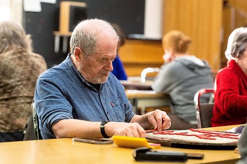 Mike Sudoma/Winnipeg Free Press
Murray Goldberg shuffles his letters around before making a move during a weekly Winnipeg Scrabble Club meetup at the Canadian Mennonite University Thursday evening
March 30, 2023 