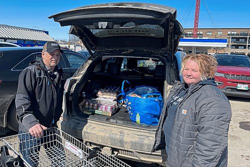 Dale and Courtney Miller pack their car after grocery shopping at Brandon's Real Canadian Superstore. (Michele McDougall/Brandon Sun)  