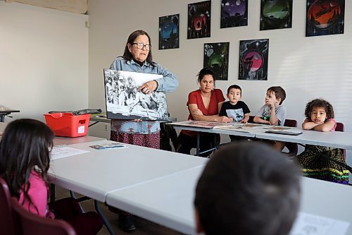 30032023
Julia Brandon of Wawezhiicabbo Wing shows students historical photos of her relatives in residential schools while teaching her weekly Anishinaabemowin language class at the Brandon Friendship Centre on Friday. The two-hour class each Friday afternoon is part of the Sixties Scoop Reclaim and Reconnect program.
(Tim Smith/The Brandon Sun)
