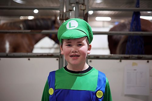 30032023
Alexander Arthur is dressed as Luigi prior to competing in the Tim Horton&#x2019;s Costume Class event along with his dad Chris and their clydesdale Bob at the Royal Manitoba Fair in The Keystone Centre on Friday evening.
(Tim Smith/The Brandon Sun)

