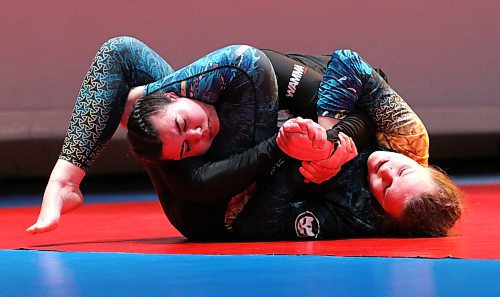 Nia Aitken of Brandon, left, and Ashley Reimer of Winnipeg find themselves tied up in an unusual position during the Brandon Bouts card at Western Manitoba Centennial Auditorium on Saturday. Reimer won in what was later judged to be the fight of the night. (Perry Bergson/The Brandon Sun)