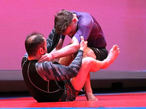 Ren Bouchard, bottom, pulls guard on opponent Kyle Schofield during their 180-pound fight. Bouchard won in overtime. (Perry Bergson/The Brandon Sun)
