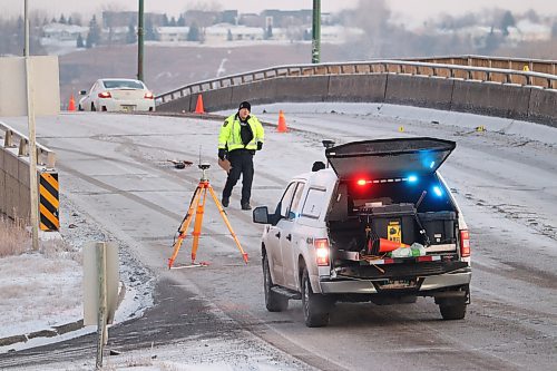 Brandon police survey the Daly Overpass Friday morning following a vehicle-pedestrian collision that took place on the bridge around 6:22 a.m. (Kyle Darbyson/The Brandon Sun)