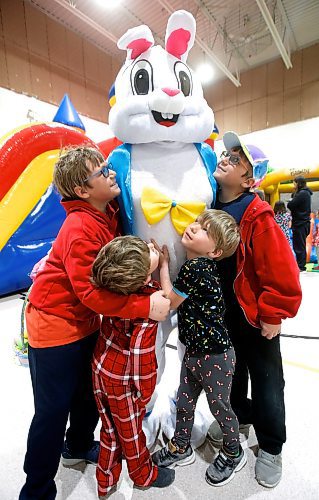 JOHN WOODS / WINNIPEG FREE PRESS
Alex Peabody, left to right, and his brothers Luke, Hunter,, and brother Aiden reach out for a hug from a person dressed as a bunny at the Bunny Bash Eggstravaganza in the Glenlawn Community Centre Sunday, April 2, 2023. Activities at the inaugural event included a scavenger hunt, a bouncy castle, arts and crafts, and skating with the bunny.

Re: ?