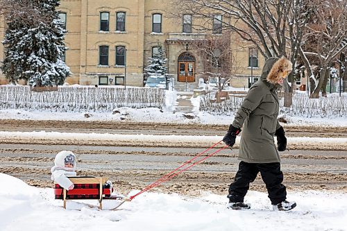 03042023
Two-year-old Lua Beaulieu is pulled through fresh snow in a sleigh by her mother Carmel Razzaghi on a Monday.
(Tim Smith/The Brandon Sun)