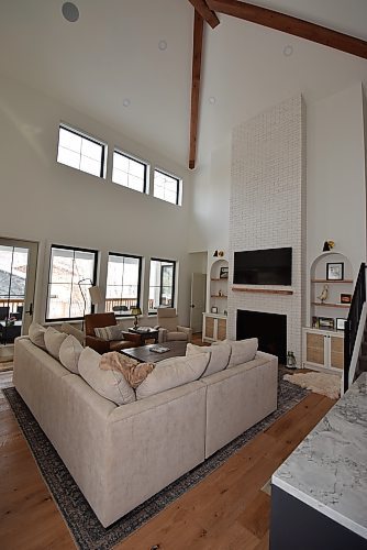 Photos by Todd Lewys / Winnipeg Free Press
Situated under a 22-foot-high beamed ceiling, the family family room is a spectacular space that's anchored by a gas fireplace with floor to ceiling white brick feature wall and a reclaimed maple mantle.