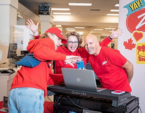 JESSICA LEE / WINNIPEG FREE PRESS

Will Lamont (left) shows Zellers GM Ewa Turski and DJ Dave Filiatrault a photo he took of the pair at the newly re-opened Zellers, on the second floor of Hudson&#x2019;s Bay at St. Vital Mall on April 4, 2023. Today is the first day of it&#x2019;s re-opening. 

Reporter: Gabby Piche