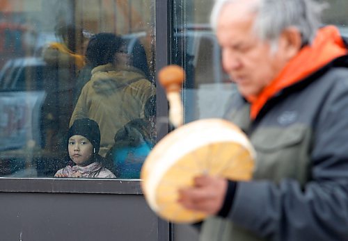 JOHN WOODS / WINNIPEG FREE PRESS
A young child looks on as elder Chris Young drums as people gather to remember Linda Mary Beardy whose body was found in Brady Landfill Tuesday, April 4, 2023. 

Re: May