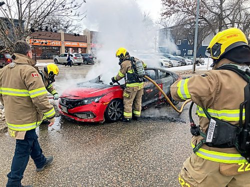 Brandon Fire and Emergency Services members respond to a car fire on Victoria Avenue west of First Street on Tuesday evening. See story on Page A2. (Tim Smith/The Brandon Sun)