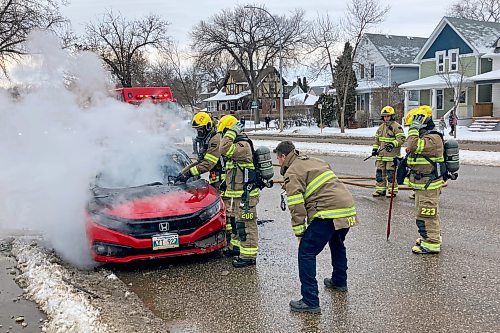 Brandon Fire and Emergency Services members respond to a car fire on Victoria Avenue west of First Street on Tuesday evening. (Tim Smith/The Brandon Sun)