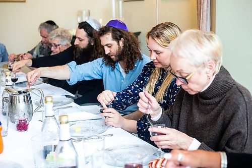 MIKAELA MACKENZIE / WINNIPEG FREE PRESS

Vira Ryabets, a recent Ukrainian newcomer, takes drops of wine out of her wine glass, representing acknowledgement of the Egyptians&#x560;pain after the plagues (compassion for enemies), at a Seder dinner marking the start of Passover in the Chodirker household in Winnipeg on Wednesday, April 5, 2023. Standup.

Winnipeg Free Press 2023.