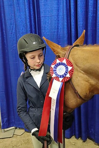 Aubree Swain poses for a photo next to her horse Partner in Crime at the Westoba Credit Union Agricultural Centre of Excellence on March 30. This year's Royal Manitoba Winter Fair Horse show marks Swain's very first entry into official competition. (Kyle Darbyson/The Brandon Sun)
