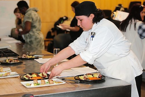 First-year Assiniboine Community College culinary student Tyra Hart serves up her entrée for evaluation during Thursday's Manitoba Pork Black Box Competition, which took place at the school's North Hill campus. Students were required to prepare an appetizer and an entrée using pork as a primary ingredient, with each dish being judged by ACC alumni and members of Manitoba Pork. (Kyle Darbyson/The Brandon Sun)
