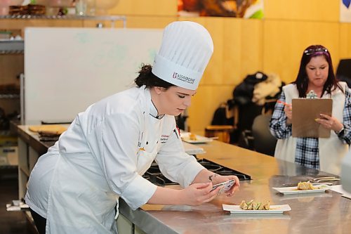 Assiniboine Community College culinary instructor Kaitlin McCarthy snaps some photos of her students' pork appetizers during during Thursday's Manitoba Pork Black Box Competition. (Kyle Darbyson/The Brandon Sun)