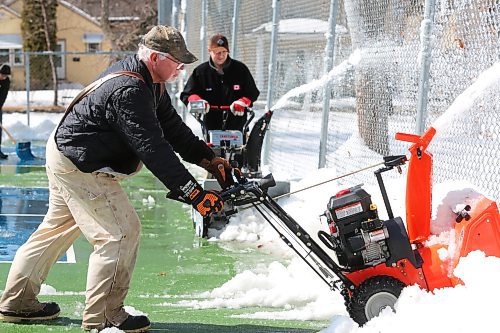 Members of the Brandon Pickleball Club clean up the pickleball courts located at Stanley Park during a mild Easter Sunday afternoon in Westman. (Kyle Darbyson/The Brandon Sun)