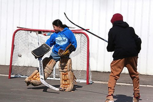 Nash Ironman sneaks a goal past Douglas Hanska during a street hockey game that took place Monday afternoon during Sioux Valley Dakota Nation's Spring Carnival event. (Kyle Darbyson/The Brandon Sun)