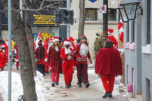 Mike Deal / Winnipeg Free Press
A street full of Santas gather at Albert Street and McDermot Avenue Monday morning during the last days of filming the Hallmark film, The Santa Summit. Production was scheduled to take place between March 24 and April 13 in Winnipeg. The feature film is about a group of friends who turn to each other for support and during the annual Santa Summit &#x201c;discover the magic of taking big chances and being vulnerable.&#x201d;
230410 - Monday, April 10, 2023.