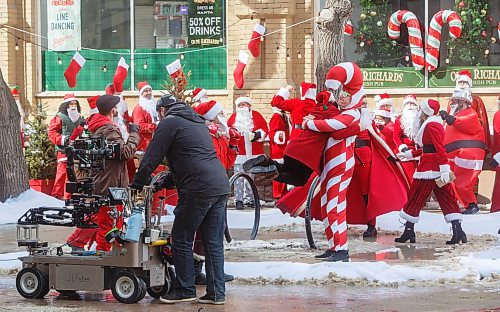 Mike Deal / Winnipeg Free Press
A street full of Santas gather at Albert Street and McDermot Avenue Monday morning during the last days of filming the Hallmark film, The Santa Summit. Production was scheduled to take place between March 24 and April 13 in Winnipeg. The feature film is about a group of friends who turn to each other for support and during the annual Santa Summit &#x201c;discover the magic of taking big chances and being vulnerable.&#x201d;
230410 - Monday, April 10, 2023.
