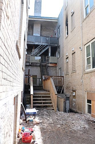 The rear exterior of the Adanac Apartments at 737 Sargent Ave. pictured April 11, 2023. City officials and residents in the area have complained about the abundance of garbage and debris surrounding the building. (Tyler Searle / Winnipeg Free Press)