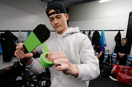 JOHN WOODS / WINNIPEG FREE PRESS
Easton Kapelus of the Lorette Scorpions, who is playing on  Winnipeg High School Hockey League (WHSHL) All-star team blue, tapes his stick in green in support of the Canadian Transplant Association&#x573; Green Shirt Day organ donor initiative in honour of the Logan Boulet Foundation at the Gateway arena in Winnipeg, Sunday, March 20, 2022. 