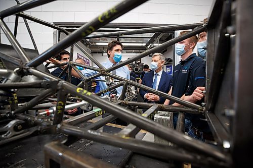 Mike Deal / Winnipeg Free Press
Prime Minister Justin Trudeau along with MP Terry Duguid (left of Trudeau) chats with engineering students while being shown the skeleton of an EV racing car that is being built in the Stanley Pauley Engineering Building at the UofM Fort Garry campus Wednesday morning. The PM is in town to announce Budget 2023 measures to help build a clean economy and visit with engineering students at the UofM Wednesday morning.
230412 - Wednesday, April 12, 2023.