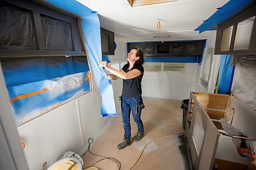 Mike Deal / Winnipeg Free Press
Maegan pulls off the masking after repainting the interior of a trailer.
Stu Pynoo and Maegan Clerihew are the duo behind ReVolution Trailers, 1480 Springfield Road, which is all about recycling, reusing and rehoming as many trailer parts as possible in an effort to reduce the number of travel trailers being dumped into landfills. They will update tired and broken trailers into &#x201c;something extraordinary&#x2019;.
See AV Kitching story
230413 - Thursday, April 13, 2023.