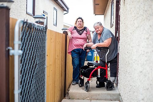 MIKAELA MACKENZIE / WINNIPEG FREE PRESS

Darcie Luzny (left) and her mom Lois Coulson pose for a photo by the troublesome step Lois needs to navigate with her walker to get in and out of the house in Winnipeg on Thursday, April 13, 2023. The provincial government recently announced $1.5 million in funding for retrofits like ramps and walk-in showers. For Malak story.

Winnipeg Free Press 2023.