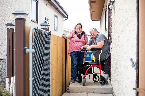 MIKAELA MACKENZIE / WINNIPEG FREE PRESS

Darcie Luzny (left) and her mom Lois Coulson pose for a photo by the troublesome step Lois needs to navigate with her walker to get in and out of the house in Winnipeg on Thursday, April 13, 2023. The provincial government recently announced $1.5 million in funding for retrofits like ramps and walk-in showers. For Malak story.

Winnipeg Free Press 2023.