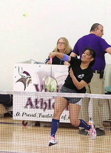 Marie Bartolome jumps in the backcourt and smashes the bird during a match in the Vincent Massey badminton tournament on Friday. She won the varsity girls event. (Perry Bergson/The Brandon Sun)