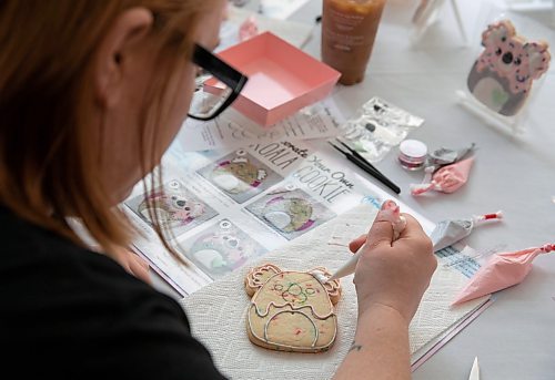 JESSICA LEE / WINNIPEG FREE PRESS

Shay Hawthorn decorates a koala-shaped cookie at the Exchange District Pharmacy on April 15, 2023 in support of Emily Heape. Dozens of people gathered for a bake sale to support Heape&#x2019;s dreams of travelling to Australia to visit her aunt, see animals not available in Manitoba and swim in the Great Barrier Reef. Heape, who lives in The Pas with her family,  was diagnosed with a brain tumour three years ago. After undergoing four rounds of chemotherapy, and eighteen rounds of radiation, doctors were able to eradicate the tumour but she still lives with health complications that affect her day to day life.

Stand up