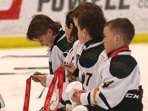 Members of the WCHA Wolves examine their gold medals after beating the Dakota Warriors 9-1 in the AAA Hockey Challenge’s final for 2014-born players at J&G Homes Arena on Sunday afternoon. (Photos by Perry Bergson/Brandon Sun)