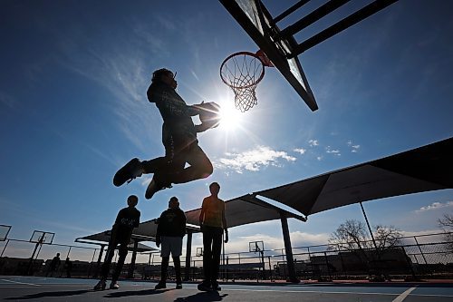 Children play basketball at the Jumpstart Court on Maryland Avenue in Brandon on a warm and sunny Monday afternoon. (Tim Smith/The Brandon Sun)