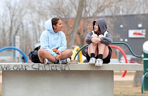 Friends Genesis Lopez and Zandria Conley visit together at Kin Park in Brandon on Tuesday. (Tim Smith/The Brandon Sun)